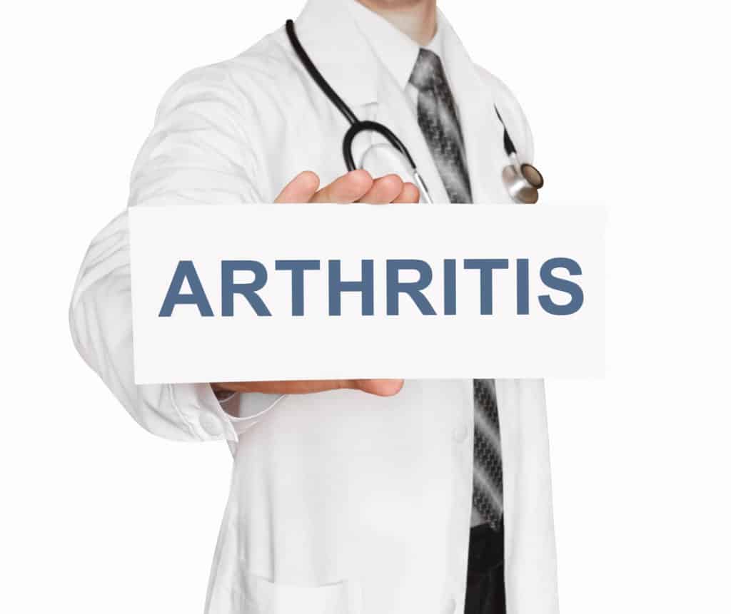 Doctor holding a card with Arthritis, Medical concept